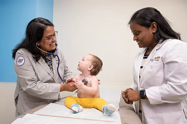 two providers examining an infant